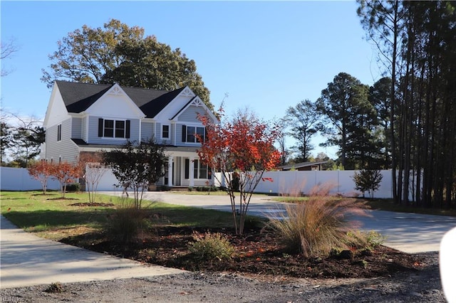 view of front of property featuring a garage and a front lawn