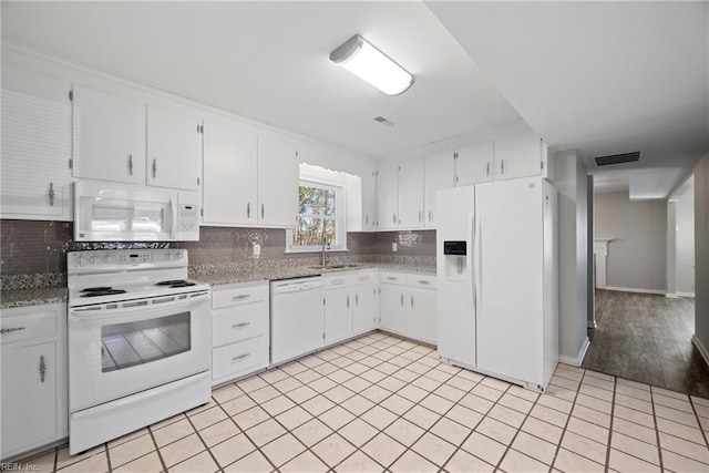 kitchen featuring sink, decorative backsplash, white appliances, and white cabinetry