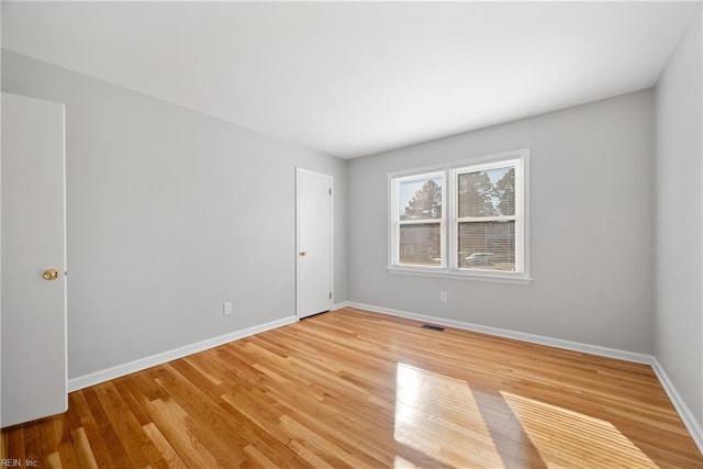 unfurnished room featuring hardwood / wood-style flooring