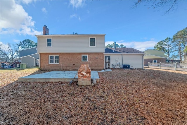 back of property with central air condition unit and a patio area