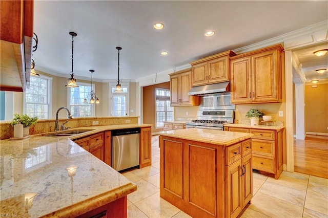 kitchen with appliances with stainless steel finishes, a center island, crown molding, pendant lighting, and sink