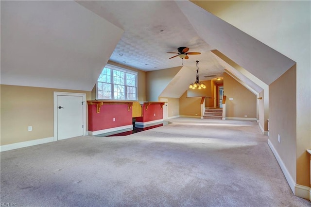 additional living space with ceiling fan with notable chandelier, vaulted ceiling, and carpet