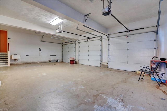 garage featuring sink and a garage door opener