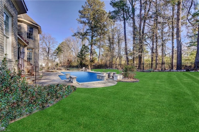 view of swimming pool featuring a patio and a lawn