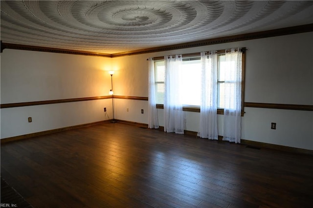 unfurnished room featuring ornamental molding and dark hardwood / wood-style flooring