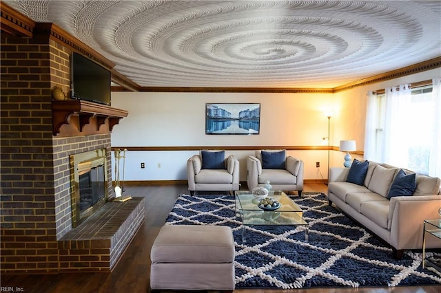 living room featuring crown molding, dark wood-type flooring, and a brick fireplace