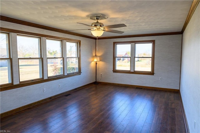 spare room with ornamental molding, ceiling fan, and dark hardwood / wood-style flooring