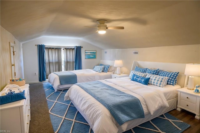 bedroom with vaulted ceiling, ceiling fan, and dark hardwood / wood-style flooring