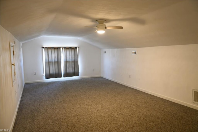 bonus room with ceiling fan, dark carpet, and lofted ceiling