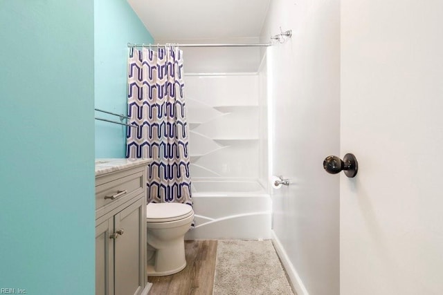 full bathroom featuring vanity, wood-type flooring, shower / bath combination with curtain, and toilet