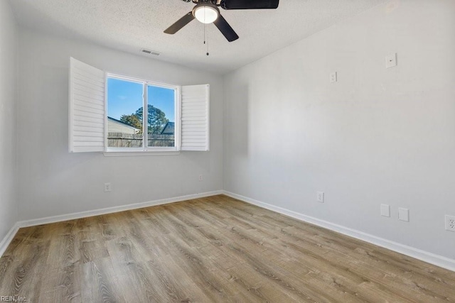 unfurnished room featuring ceiling fan, a textured ceiling, and light wood-type flooring