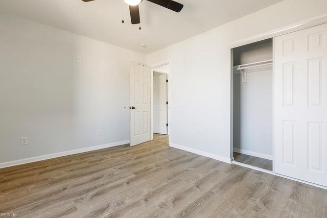 unfurnished bedroom with light hardwood / wood-style floors, a closet, and ceiling fan