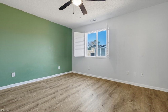 unfurnished room with ceiling fan, a textured ceiling, and light hardwood / wood-style floors