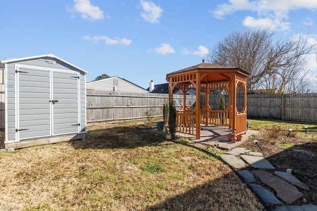 view of yard with a gazebo and a storage unit