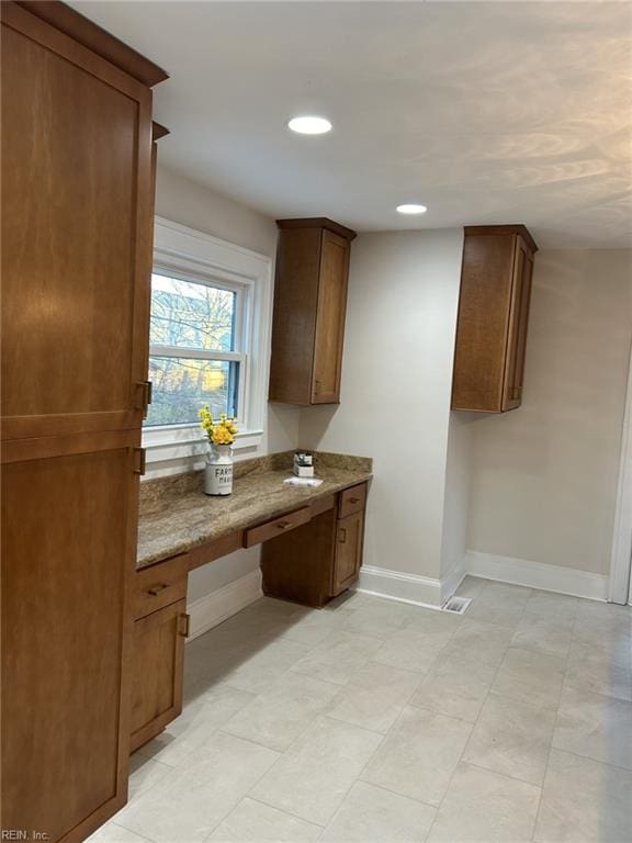 kitchen featuring sink and dark stone countertops