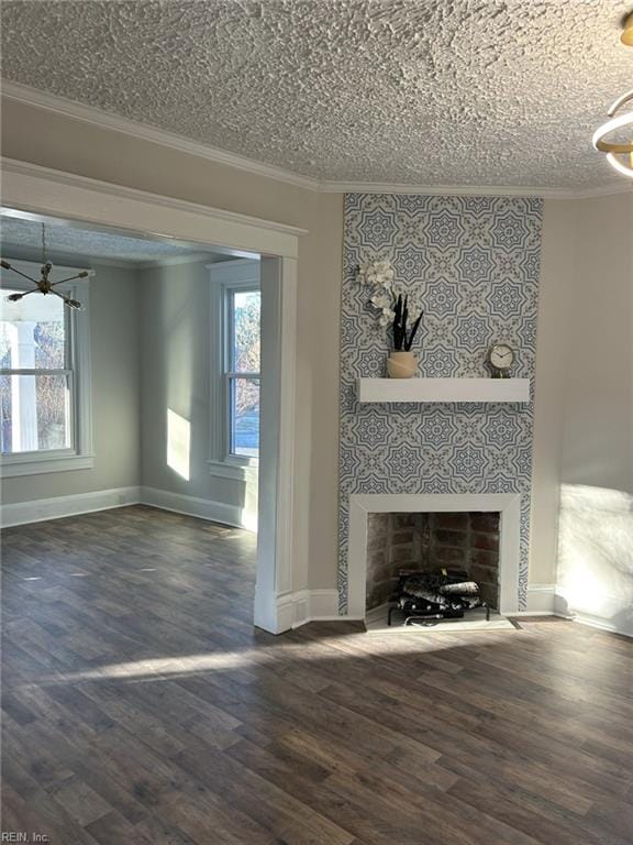 unfurnished living room with a wealth of natural light, dark hardwood / wood-style floors, crown molding, and a tiled fireplace