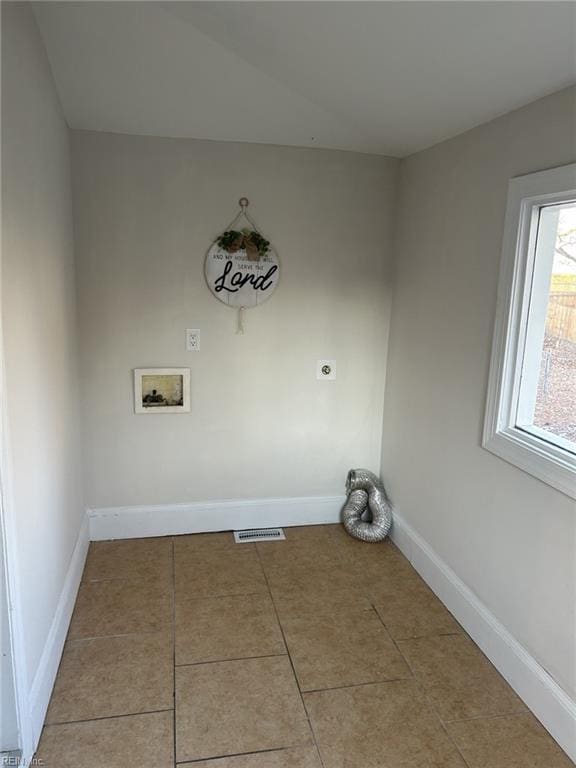 laundry room with hookup for an electric dryer, washer hookup, and light tile patterned floors