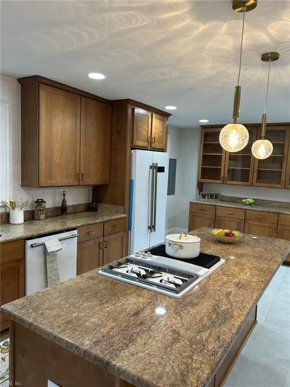 kitchen featuring a center island, stainless steel gas cooktop, high end fridge, dishwashing machine, and electric panel