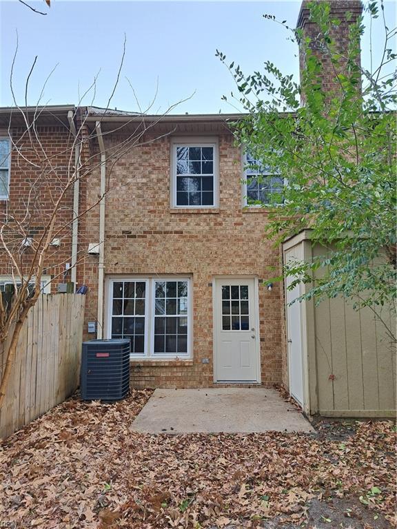 rear view of property with cooling unit and a patio area