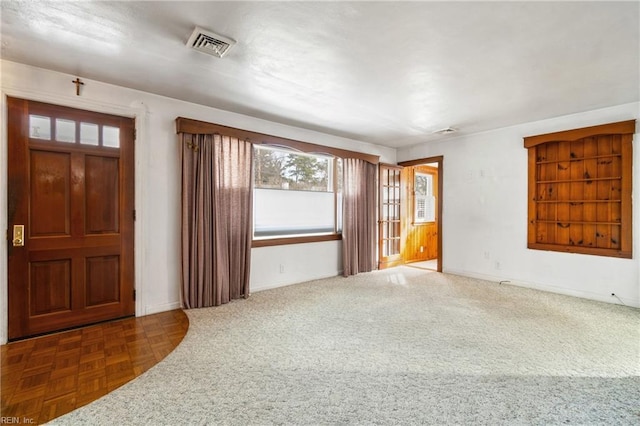 entryway with dark parquet floors