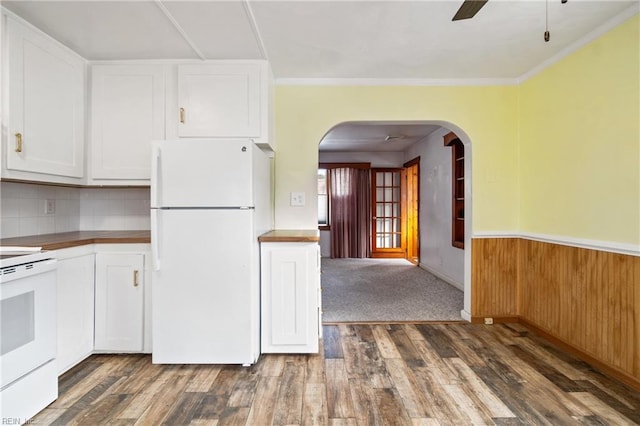 kitchen with white cabinets, dark wood-type flooring, white appliances, and ornamental molding