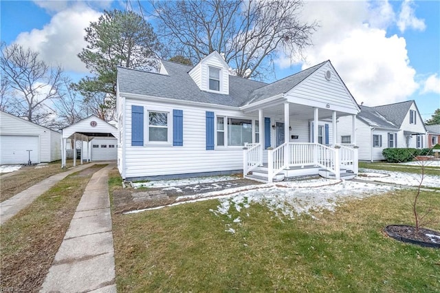 cape cod house with a front yard, a garage, a carport, and covered porch