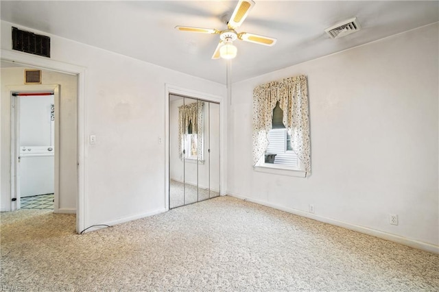 unfurnished bedroom featuring carpet, ceiling fan, washer / clothes dryer, and a closet