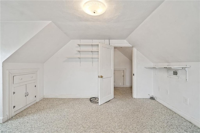 additional living space featuring light carpet and lofted ceiling