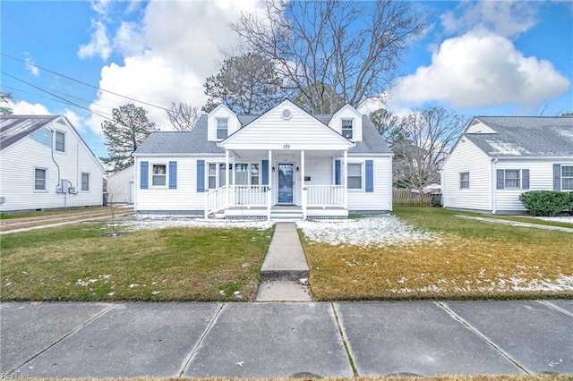 cape cod-style house with covered porch and a front yard