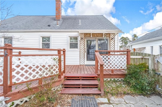 back of property featuring a wooden deck