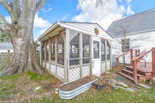 view of side of home with a sunroom