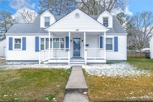 cape cod-style house with a porch and a front yard