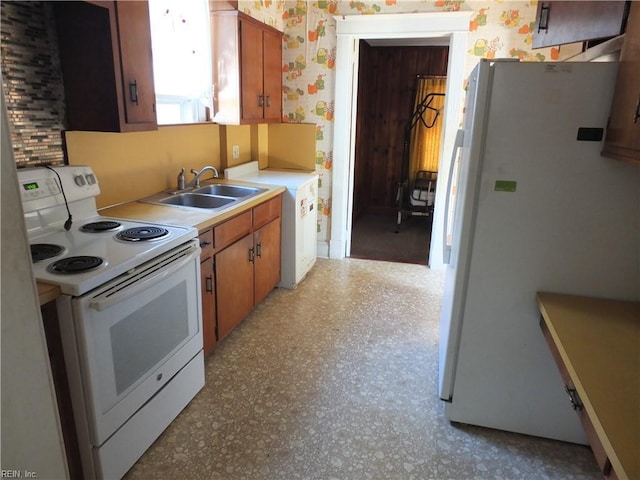 kitchen featuring white appliances and sink