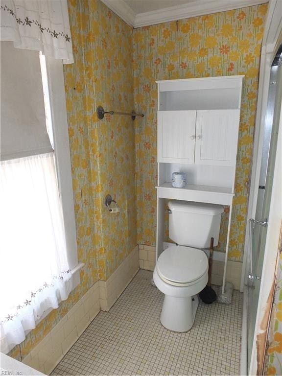 bathroom featuring crown molding, tile patterned flooring, and toilet