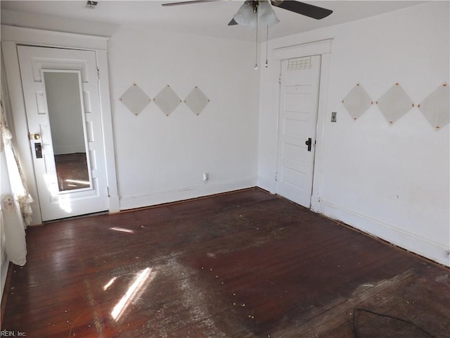 spare room with ceiling fan and dark wood-type flooring