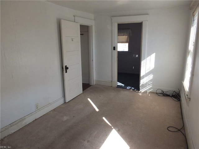 empty room with carpet flooring and a wealth of natural light