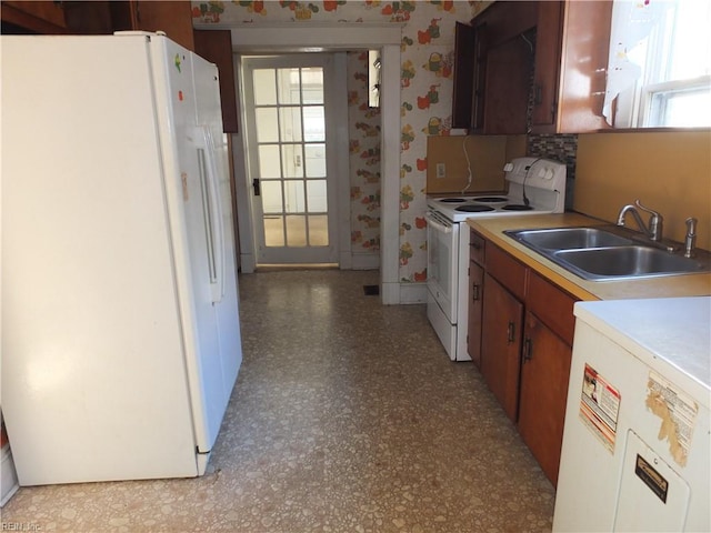 kitchen with sink and white appliances