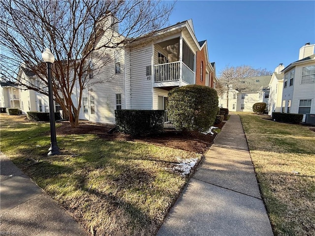 view of side of property with a lawn