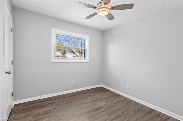 empty room with ceiling fan and dark hardwood / wood-style flooring