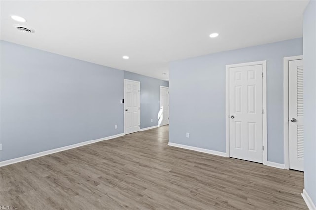 spare room featuring wood-type flooring