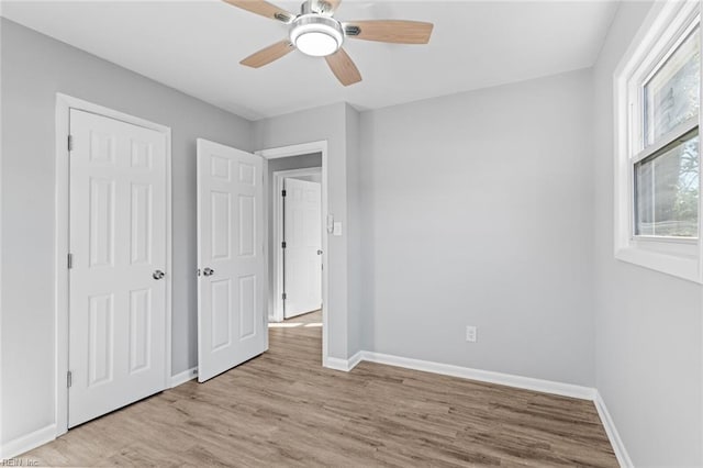 unfurnished bedroom featuring ceiling fan and light hardwood / wood-style floors