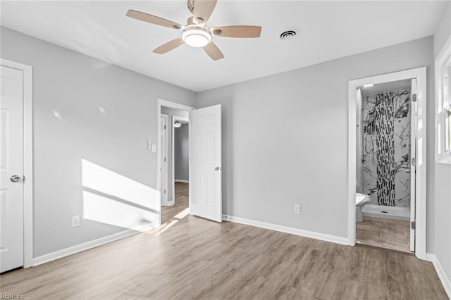 unfurnished bedroom with ceiling fan, connected bathroom, and light hardwood / wood-style flooring