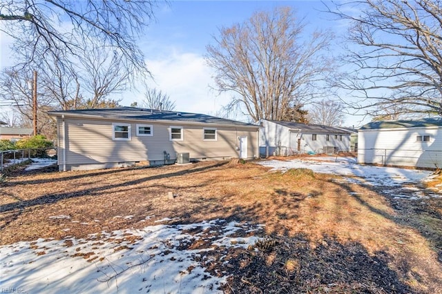 snow covered property with cooling unit