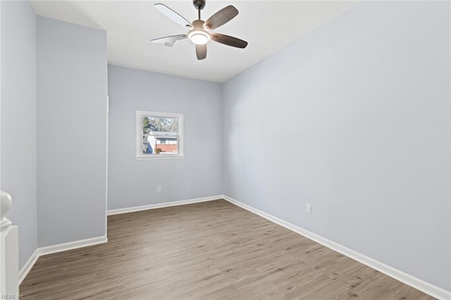 empty room featuring ceiling fan and hardwood / wood-style flooring