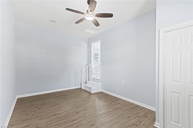 spare room with ceiling fan and wood-type flooring