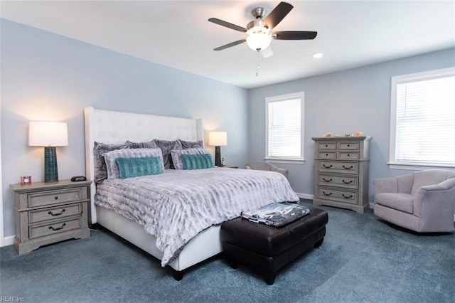 carpeted bedroom featuring multiple windows and ceiling fan