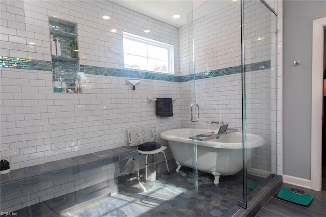 bathroom featuring tile patterned flooring, tile walls, and independent shower and bath