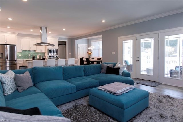 living room with hardwood / wood-style floors and ornamental molding