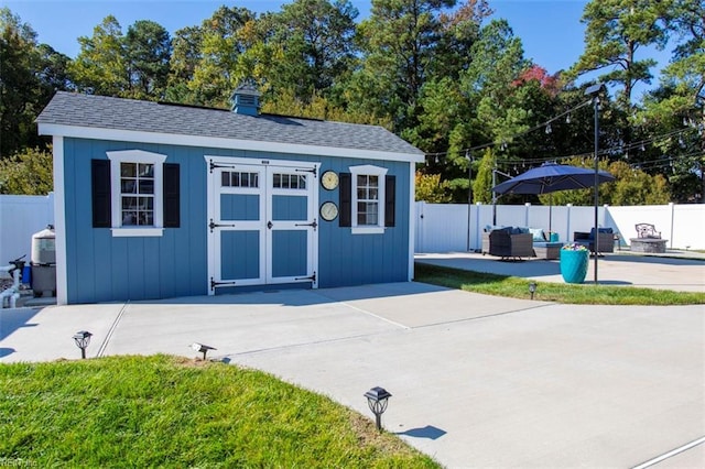 view of outbuilding with outdoor lounge area and a lawn