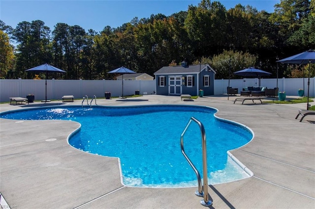 view of pool featuring an outdoor living space, a patio area, and an outdoor structure